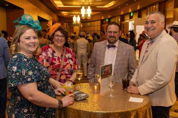 Two couples dressed in Kentucky Derby attire at BCI's Derby After Dark 2025 gala