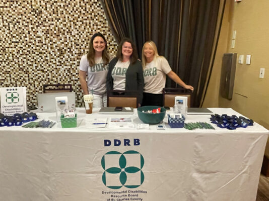 Three women working DDRB booth
