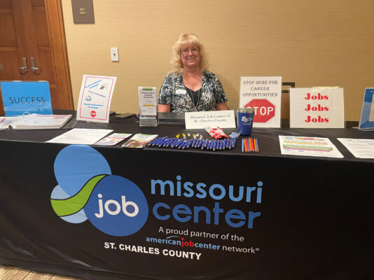 One woman working Missouri Job Center booth