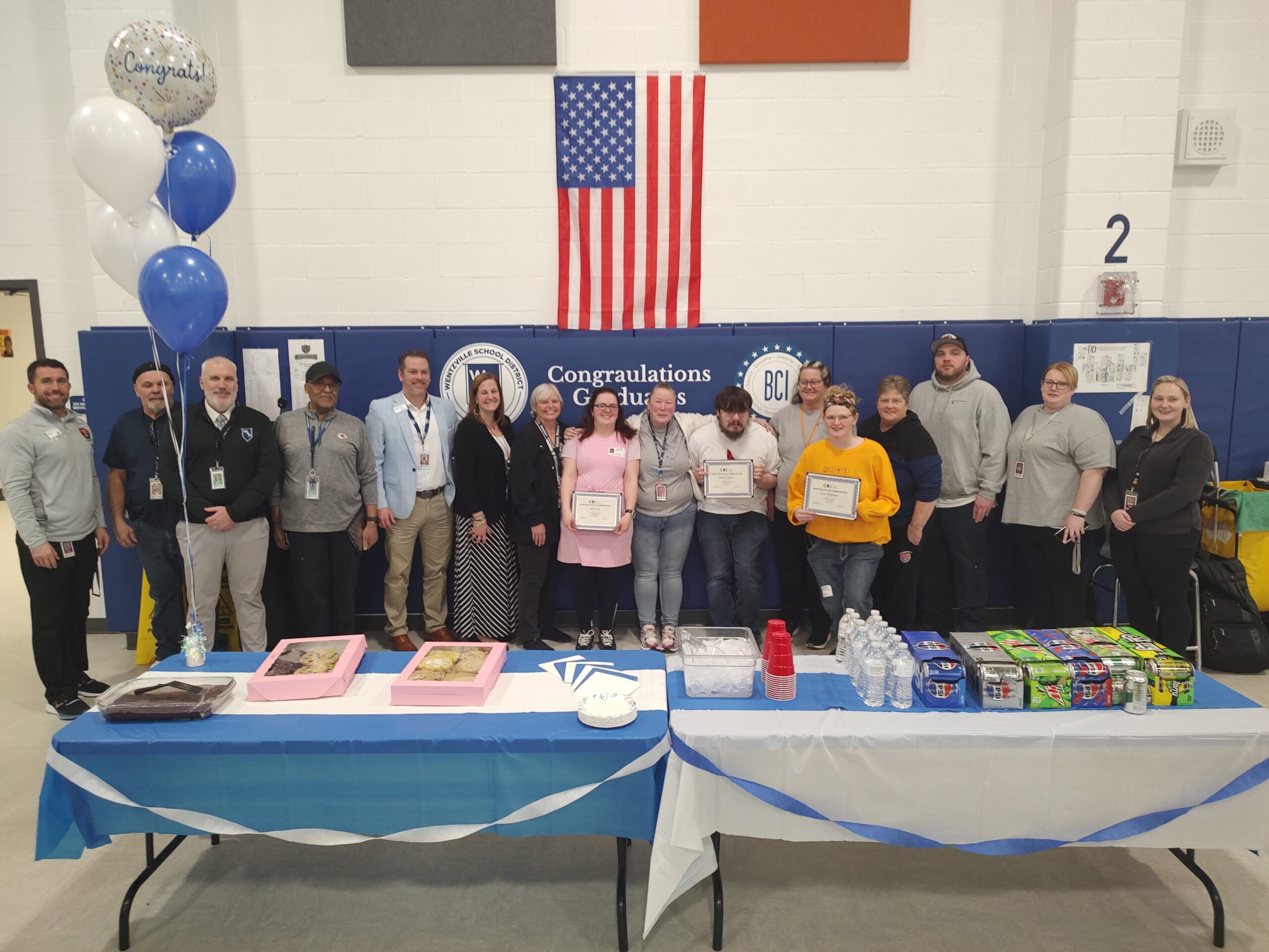Students with disabilities holding their certificates