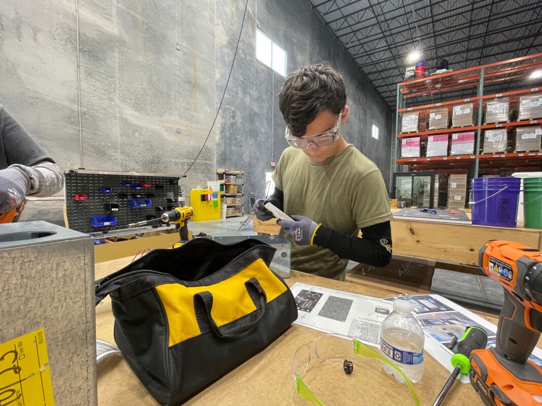 Vocational training student doing ballast box lesson