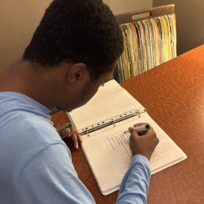 Young man using checklist for vocational training