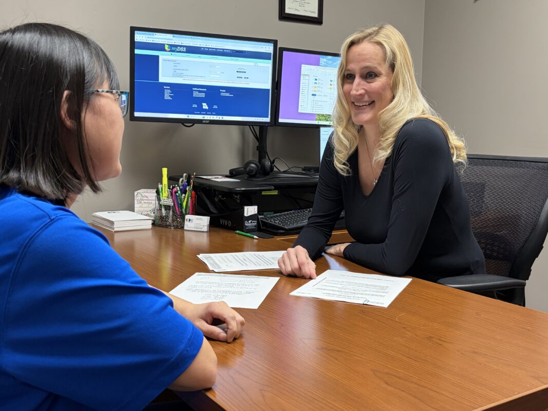Woman counseling a young woman on public benefits