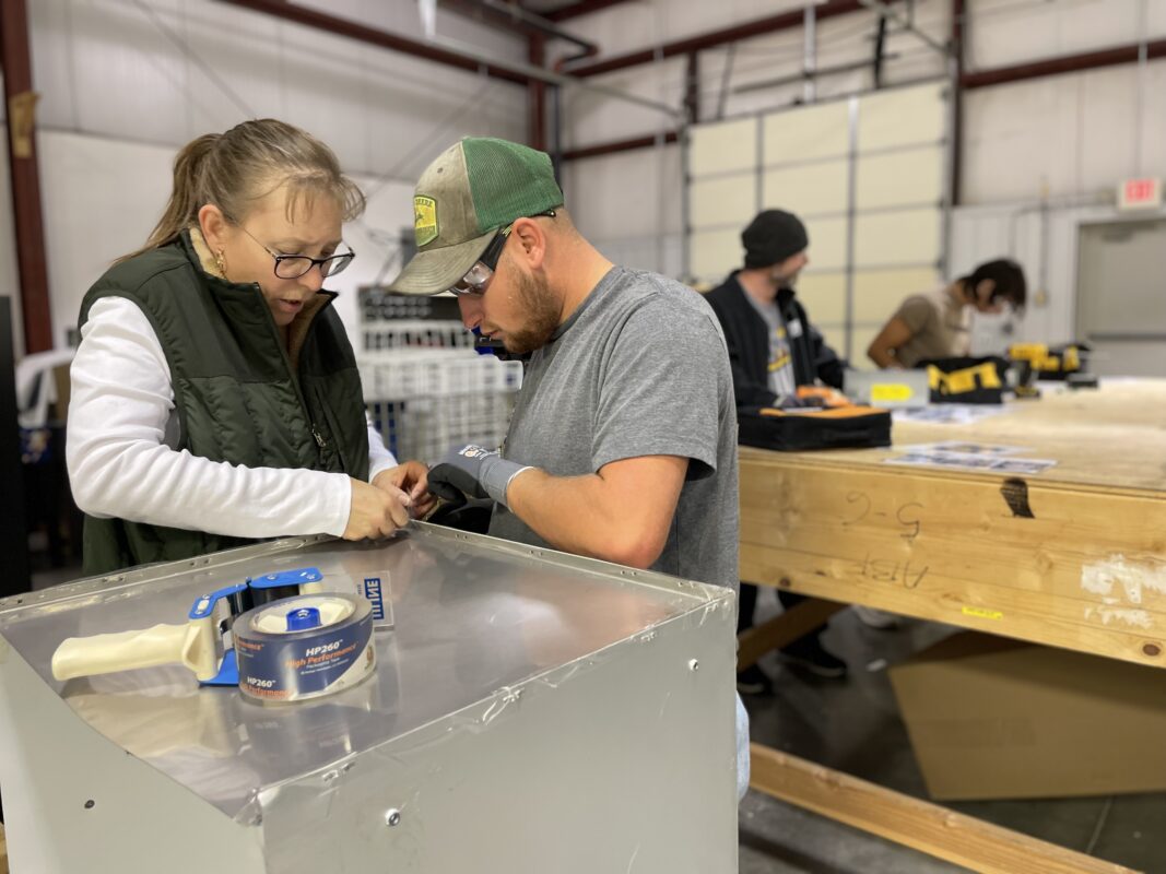 Vocational training participants working with instructor